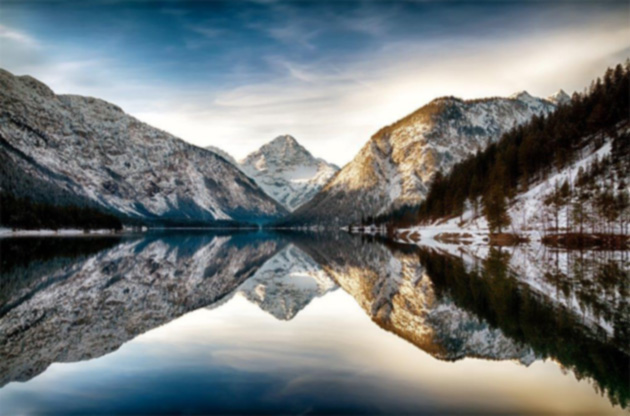 Photo of mountain reflected in a lake. Inspirational image of peaceful setting